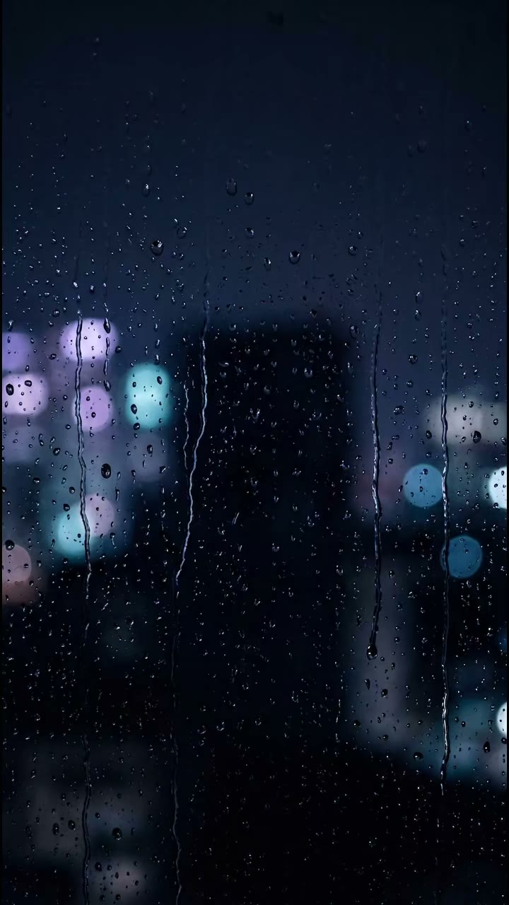 Rain on a window with city lights